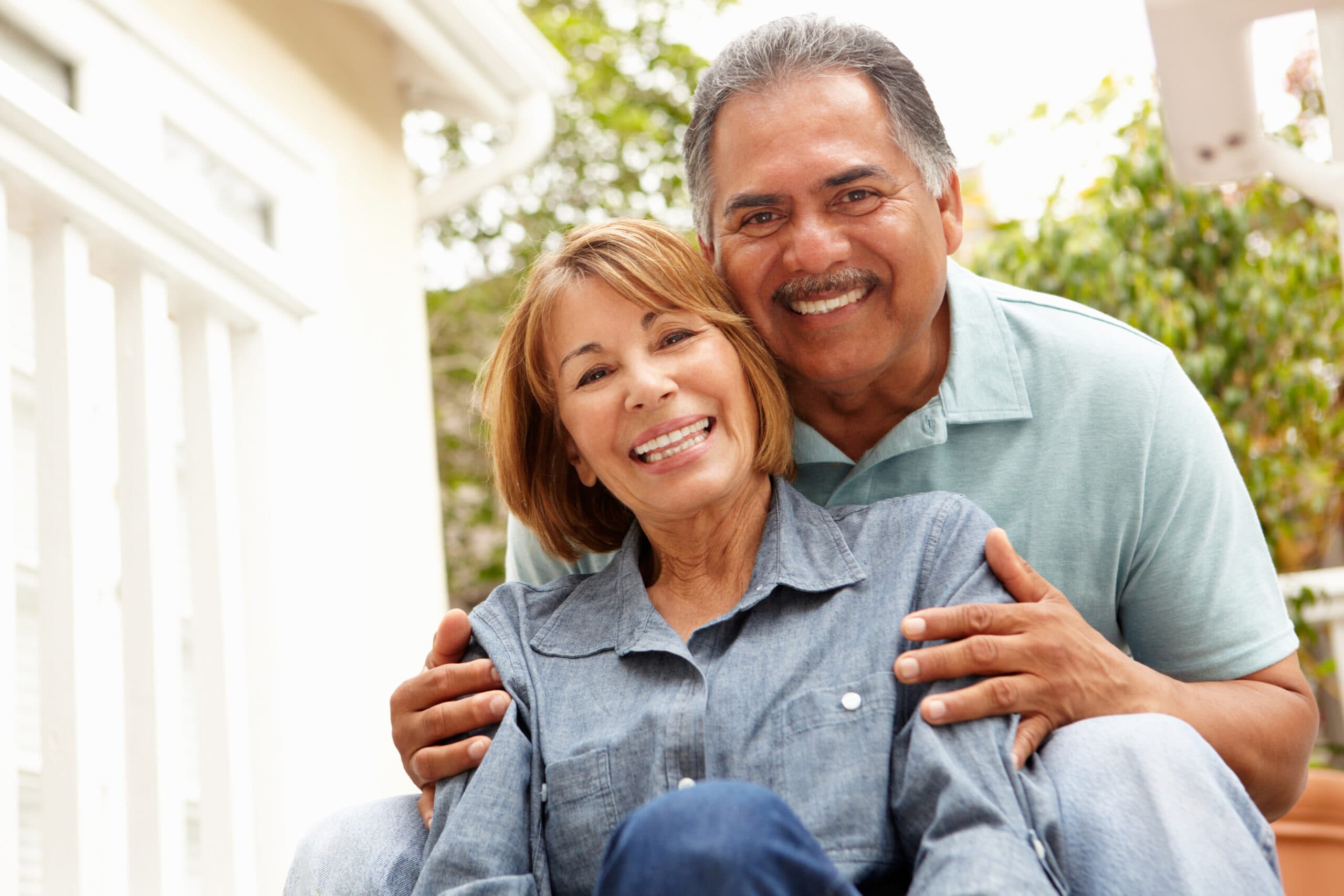 Older couple smiling in garden